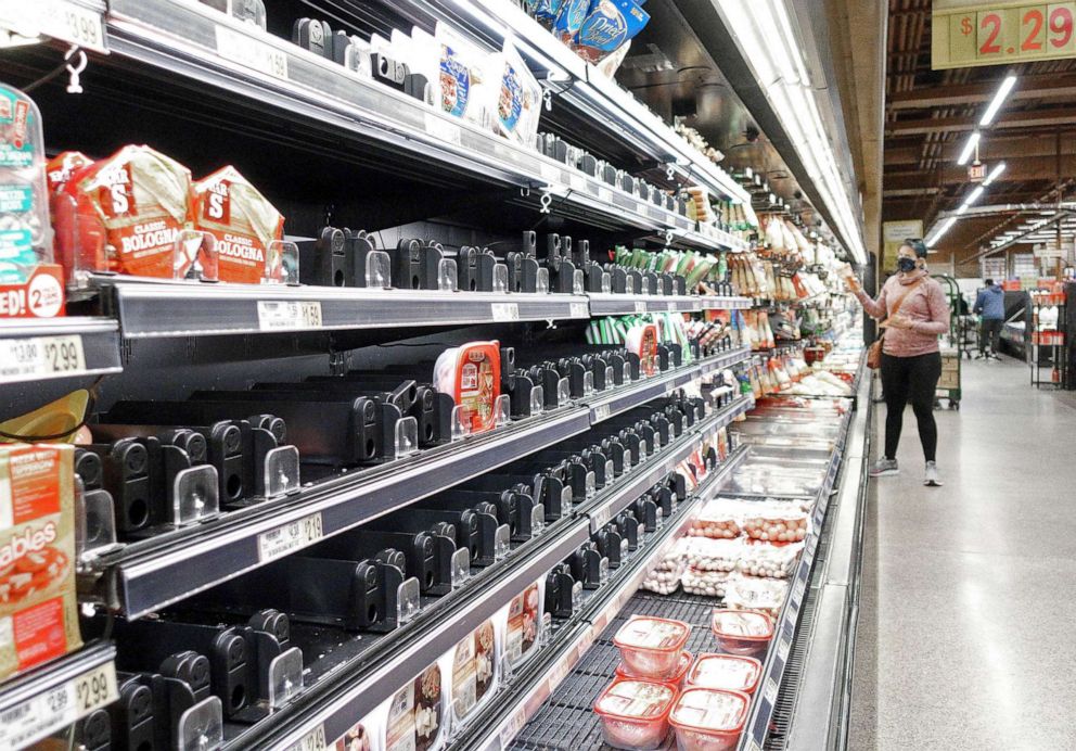 PHOTO: Shelves that held ham products are partially empty at a grocery store due to supply chain disruptions, Omicron and winter storms, on Jan. 13, 2022, in Fairfax Va. 