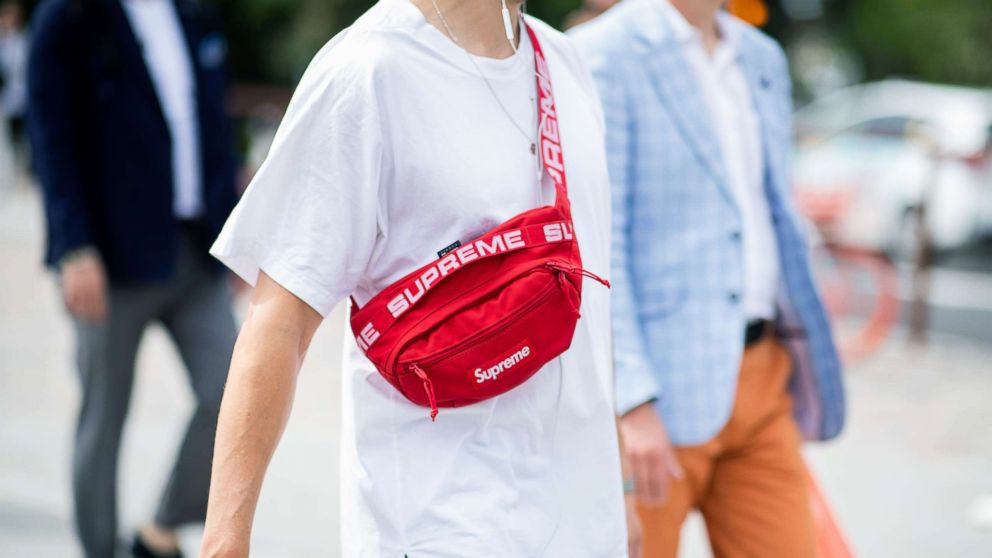 A guest wearing red Supreme belt bag is seen during the 94th Pitti Immagine Uomo, June 14, 2018, in Florence, Italy.