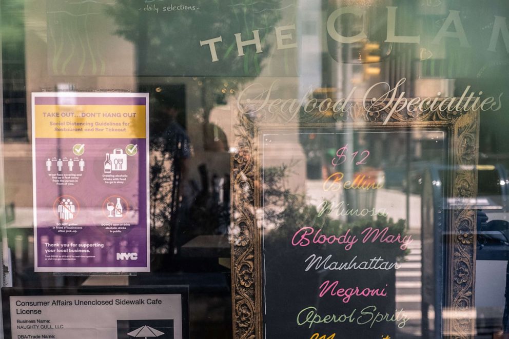 PHOTO: A sign reads "Take Out. Don't Hang Out" outside the Clam restaurant in the West Village neighborhood of New York, U.S., on Saturday, June 20, 2020.