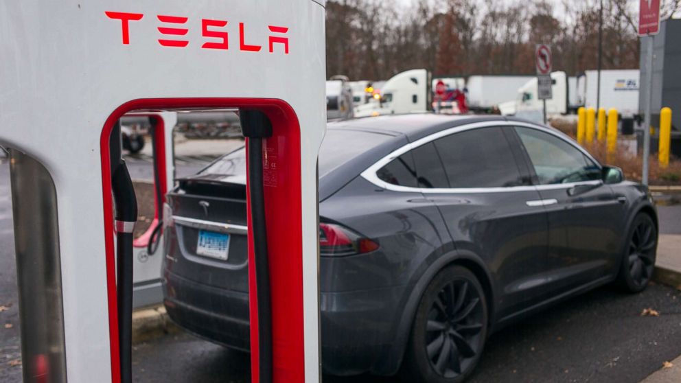 PHOTO: A Tesla X electric automobile recharges at a public charging station along Interstate 95 in Darien, Conn., Dec. 5, 2017.