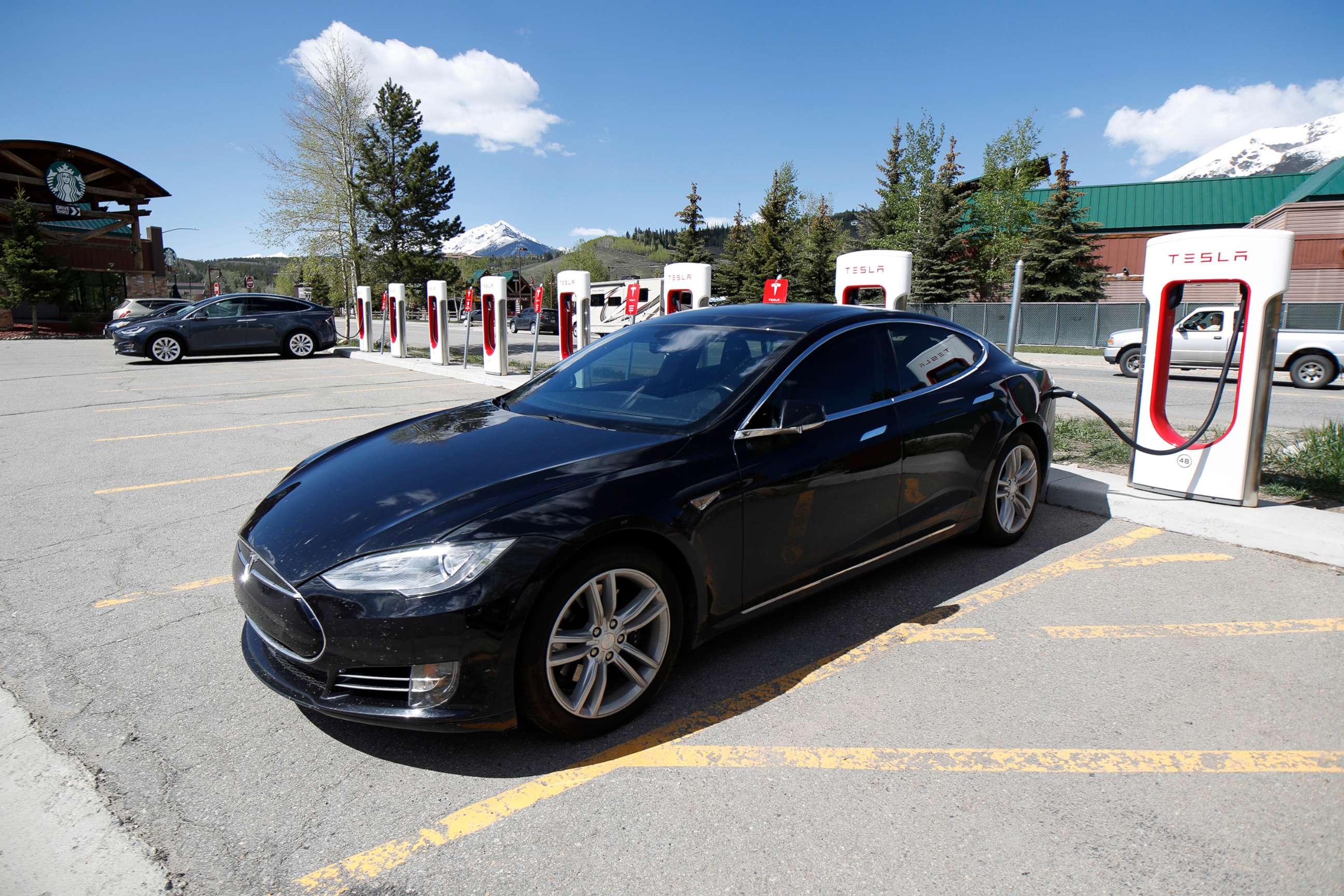 PHOTO: A Tesla Model S sedan charges at a supercharging station in Silverthorne, Colo. on June 8, 2019.