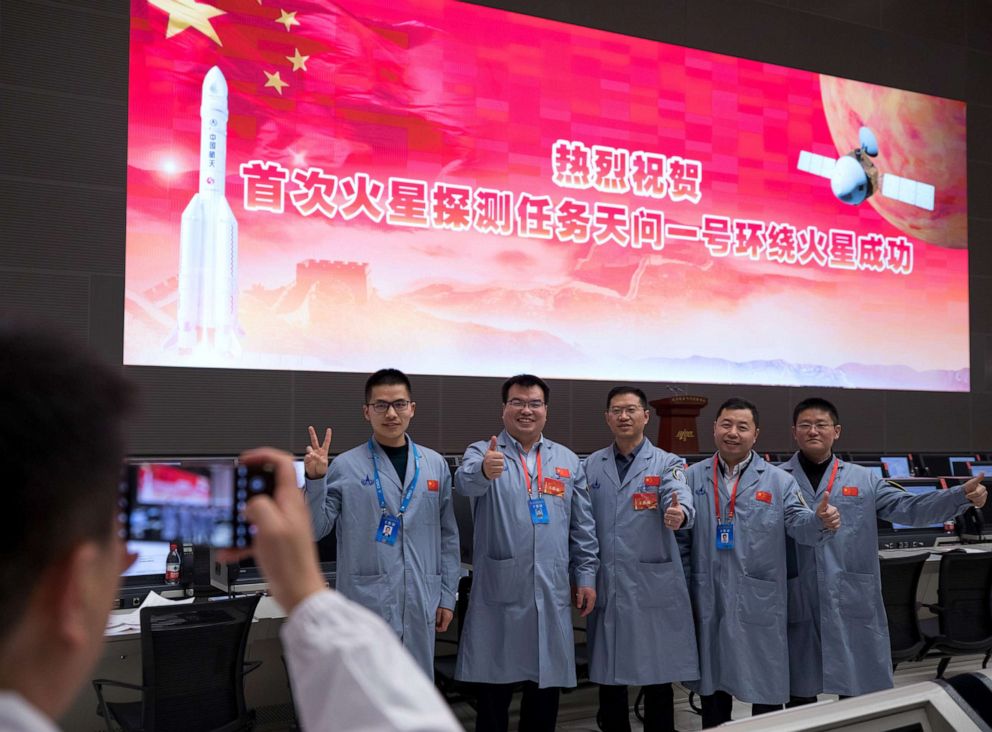 PHOTO: Technical personnel celebrate after China's Tianwen-1 probe successfully entered the orbit around Mars at the Beijing Aerospace Control Center in Beijing, Feb. 10, 2021.