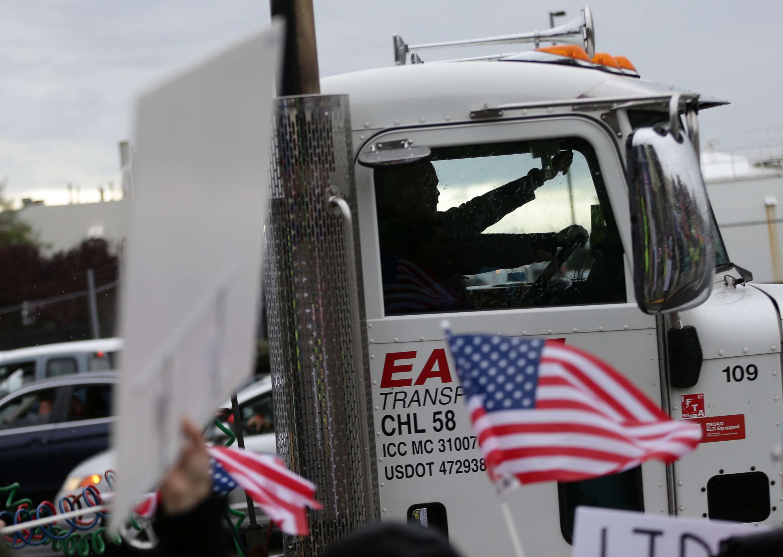 PHOTO: A truck driver honks while passing by Boeing employees and others protesting the company's coronavirus disease vaccine mandate, outside the Boeing facility in Everett, Wash., Oct. 15, 2021.