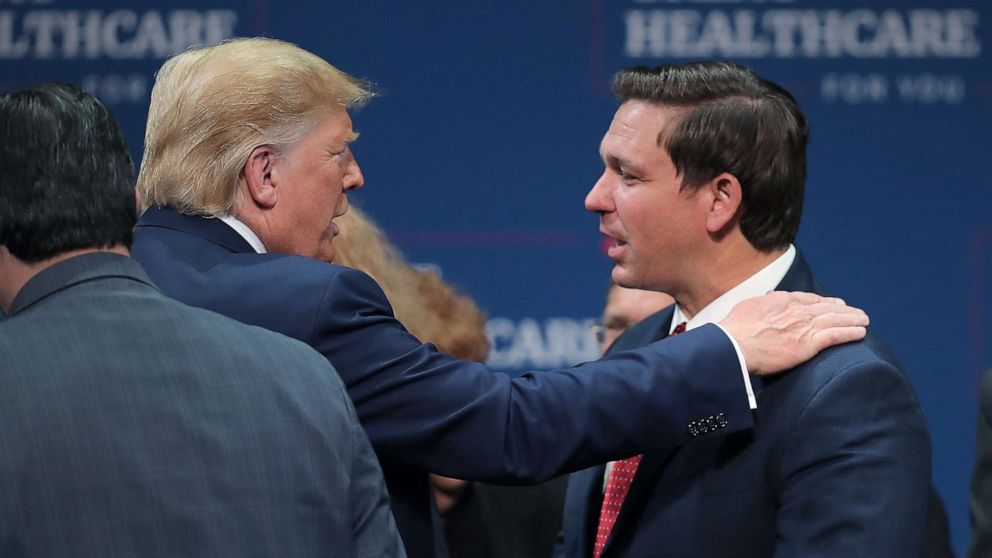 PHOTO: President Donald Trump speaks with Florida Gov. Ron DeSantis during an event, Oct. 3, 2019, in The Villages, Fla.
