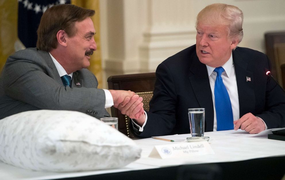 PHOTO: President Donald Trump shakes hands with Mike Lindell, left, founder of My Pillow, during a Made in America event with US manufacturers in the East Room of the White House in Washington, D.C., July 19, 2017.