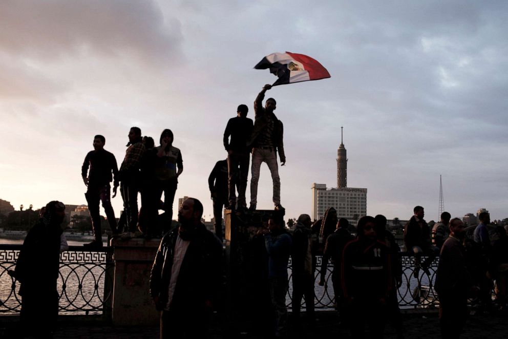 PHOTO: Egyptian protesters stand on a fence by the River Nile during a protest against Egyptian President Mohammed Morsi near Tahrir Square on Feb. 1, 2013.