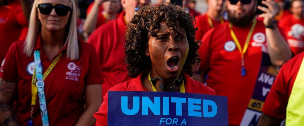 PHOTO: Phaedra Grant, who has worked 34 years for Ford, holds a sign during a United Auto Workers rally to support striking workers outside an assembly plant in Louisville, Kentucky, on Sept. 21, 2023.