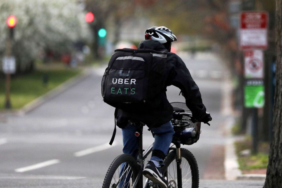 PHOTO: An Uber Eats bicyclist makes a delivery during the coronavirus outbreak, in the U.S. Capitol Hill neighborhood in Washington, U.S. April 1, 2020.