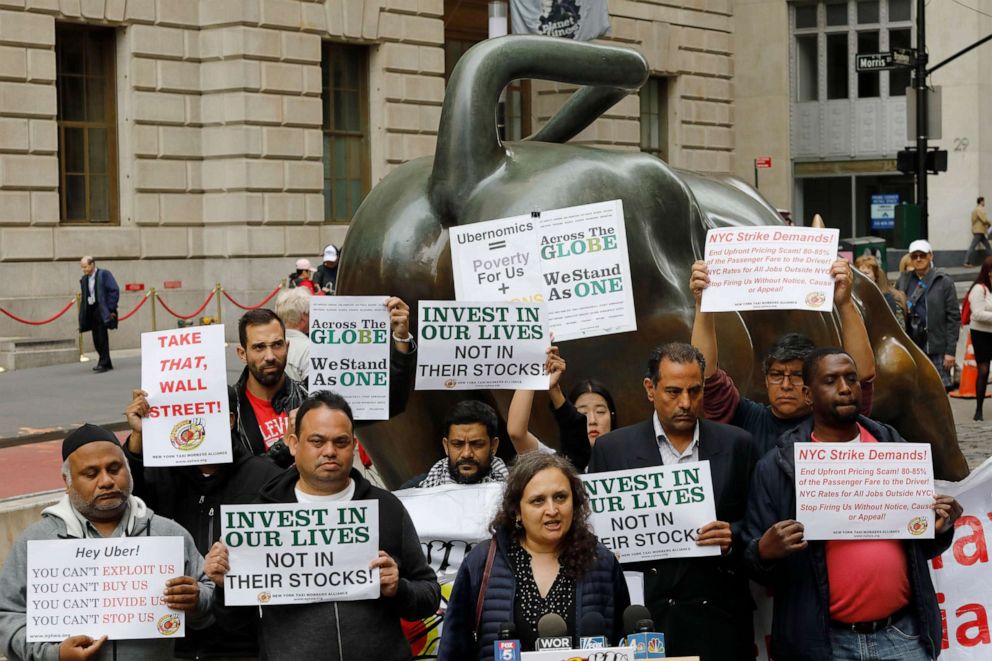 PHOTO: Uber drivers protest next to the Charging Bull statue in New York's financial district, May 8, 2019. The protests arrive just ahead of Uber's initial public stock offering, which is planned for Friday. 