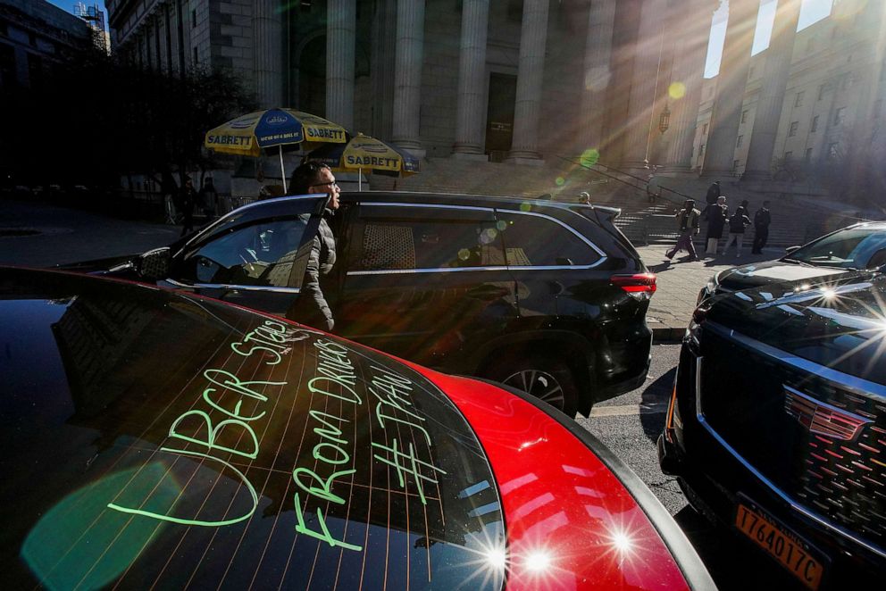 PHOTO: A driver with the ride-sharing company Uber shouts slogans against the company as they take part in a protest against a lawsuit which aims to block pay raises ordered by New York City Taxi and Limousine Commission in New York City, Dec. 19, 2022.