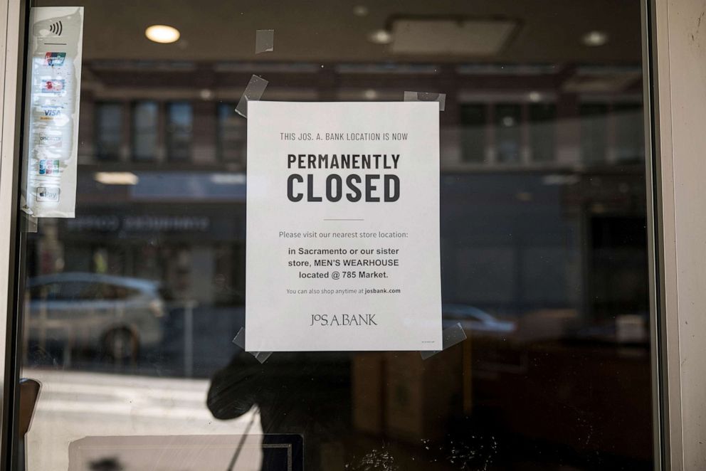 PHOTO: Signage informing people that the Jos. A. Bank store in permanently closed is displayed on the door of the vacant store in San Francisco, Calif., Aug. 6, 2020.