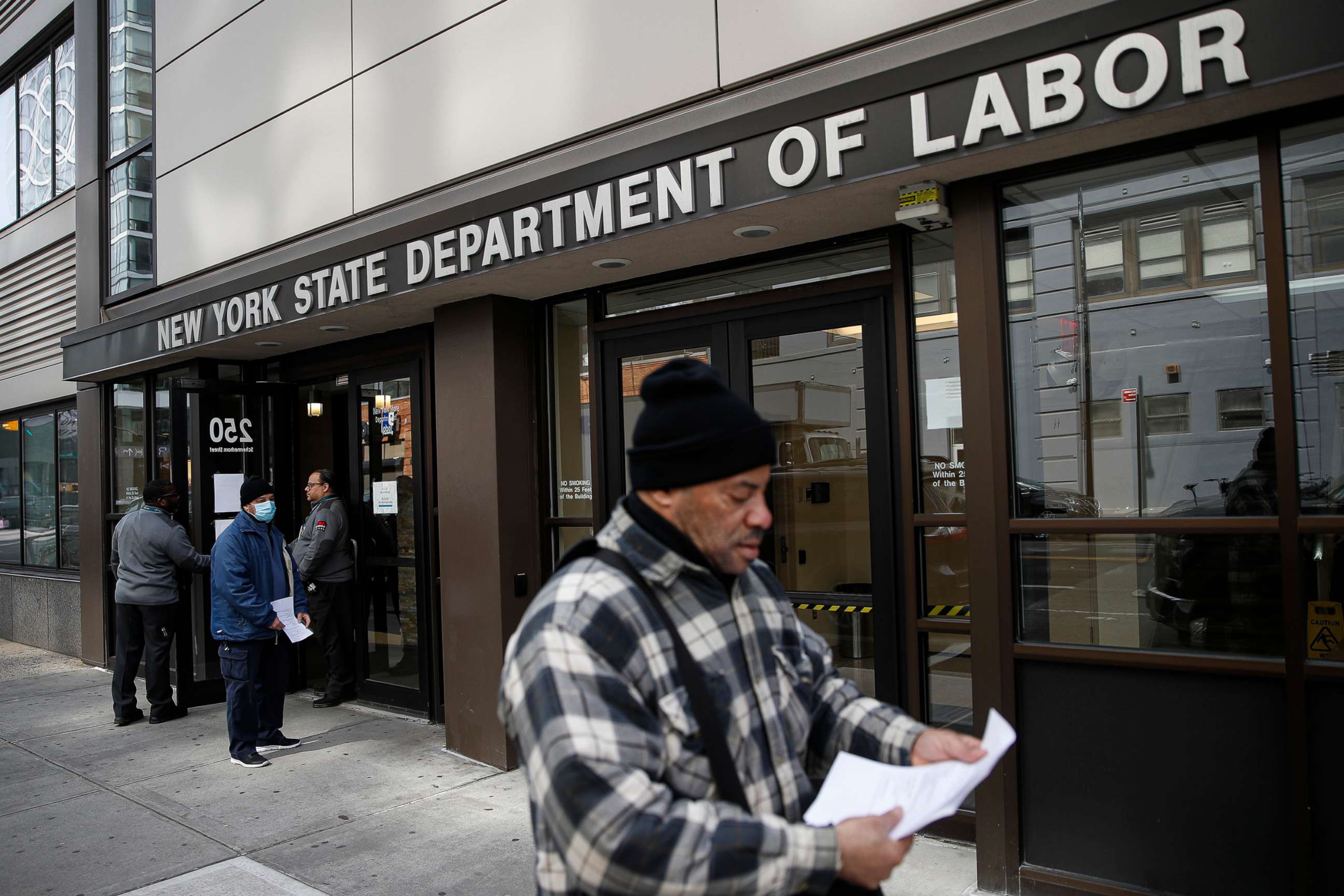 PHOTO: Visitors to the Department of Labor are turned away at the door by personnel due to closures over coronavirus concerns in New York, March 18, 2020. 