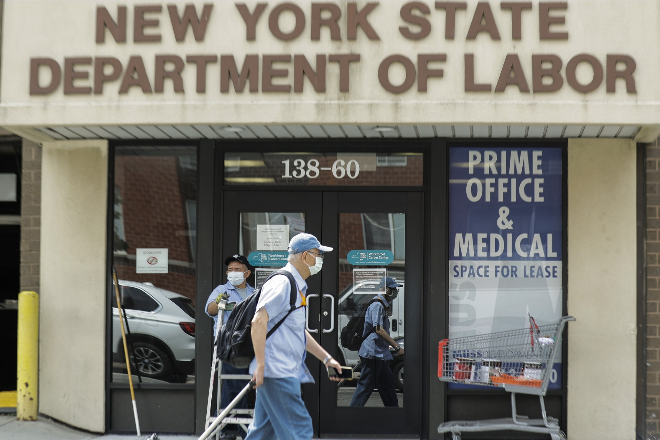 PHOTO:Pedestrians pass an office location for the New York State Department of Labor, June 11, 2020, in New York.