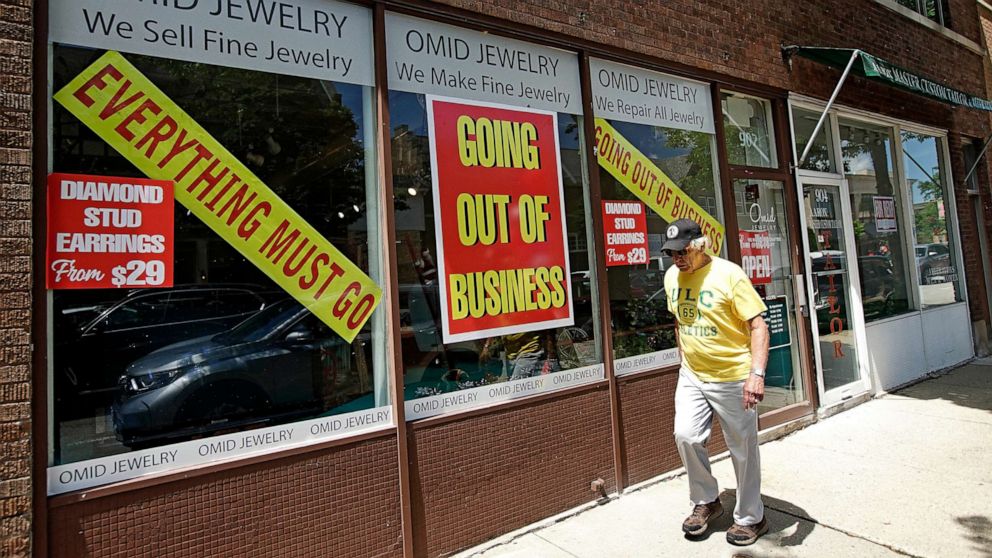 PHOTO: A man walks past a retail store that is going out of business due to the coronavirus pandemic in Winnetka, Ill., June 23, 2020.