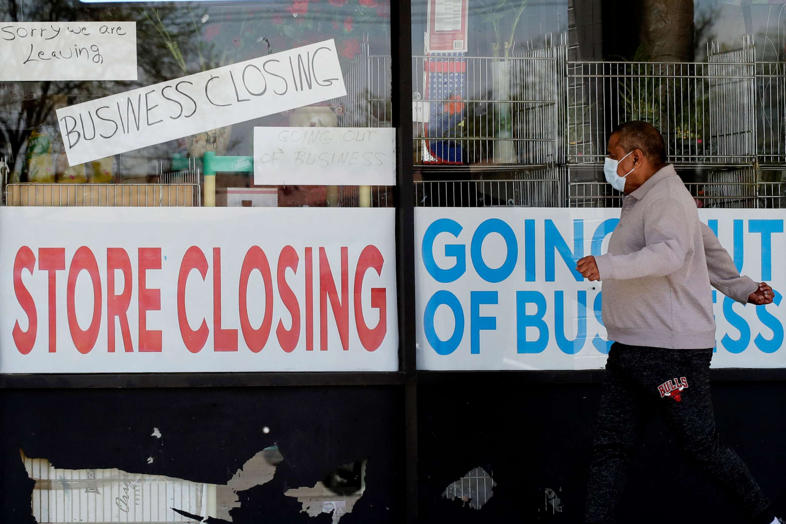 PHOTO:A man looks at signs of a closed store due to COVID-19 in Niles, Ill., May 21, 2020.