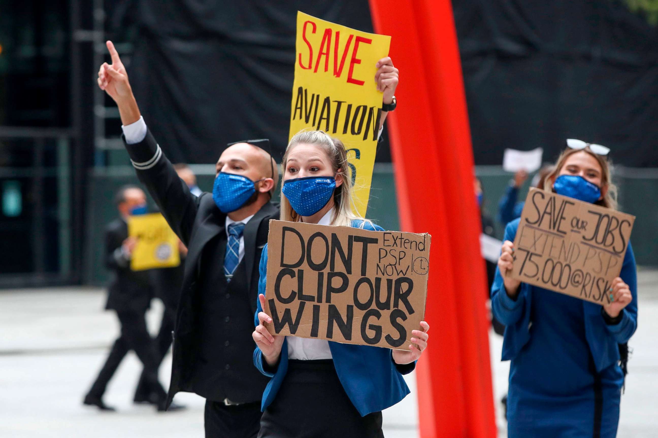 PHOTO: Airline industry workers hold signs during a protest urging Congress to pass a Covid-19 relief package and extend the Paycheck Support Program to save aviation jobs in Federal Plaza in Chicago,  on Sept. 9, 2020. 