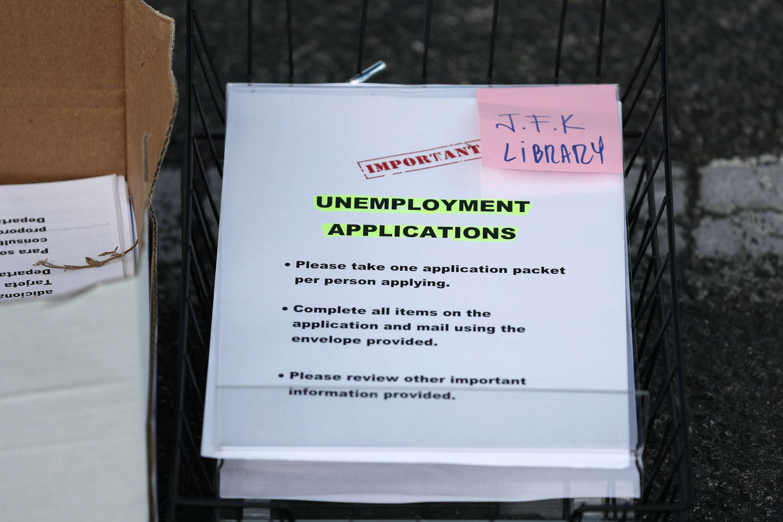 PHOTO: Unemployment applications are  seen as City of Hialeah employees hand them out to people in front of the John F. Kennedy Library, April 8, 2020, in Hialeah, Fla.