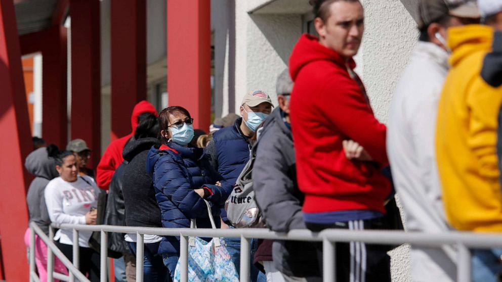 PHOTO: People wait in line for help with unemployment benefits at the One-Stop Career Center in Las Vegas, March 17, 2020.