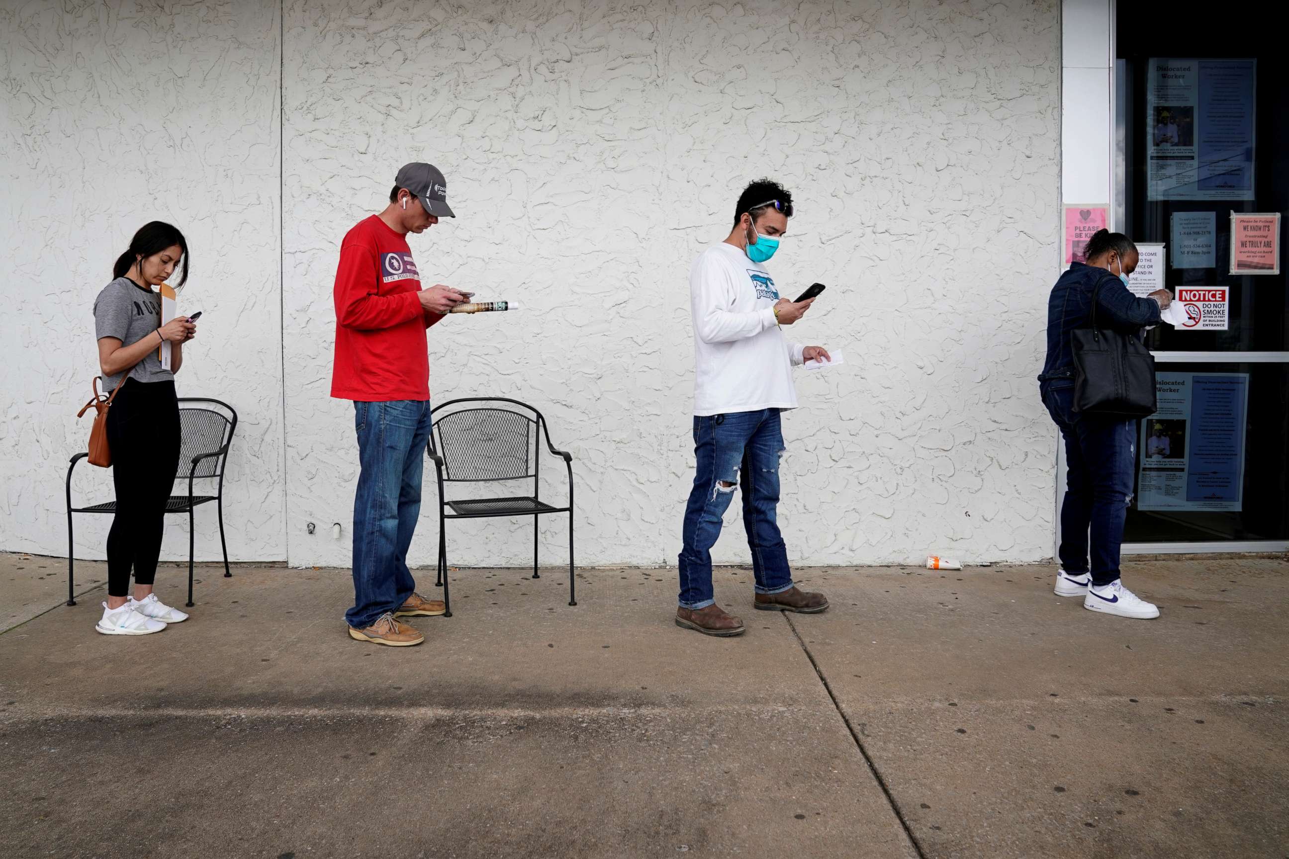PHOTO: People who lost their jobs wait in line to file for unemployment following an outbreak of the coronavirus disease (COVID-19), at an Arkansas Workforce Center in Fayetteville, Arkansas, April 6, 2020.