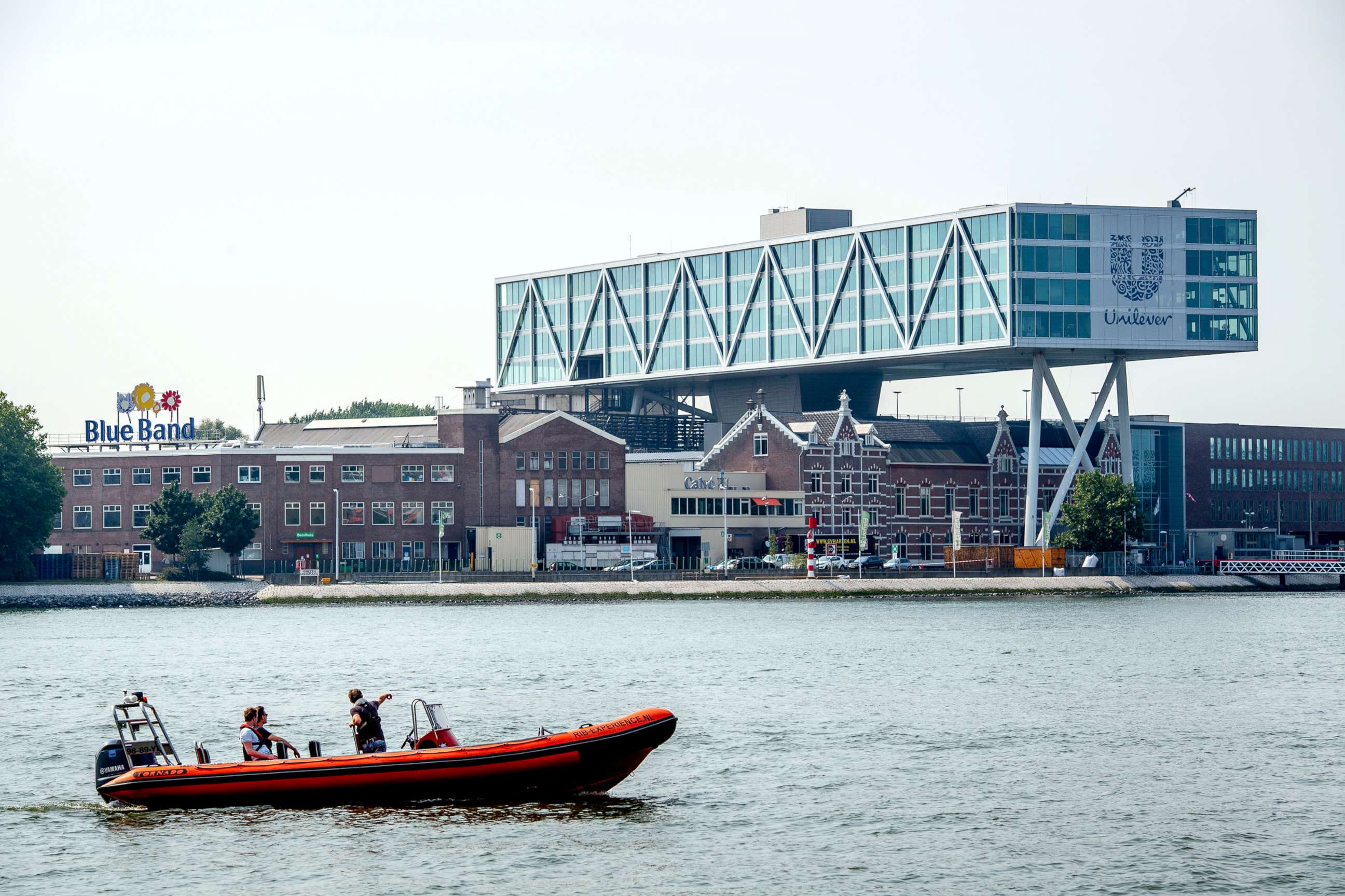 PHOTO: The Unilever headquarters building above the Nieuwe Maas river as a boat passes by, Aug. 11, 2020, in Rotterdam, Netherlands.
