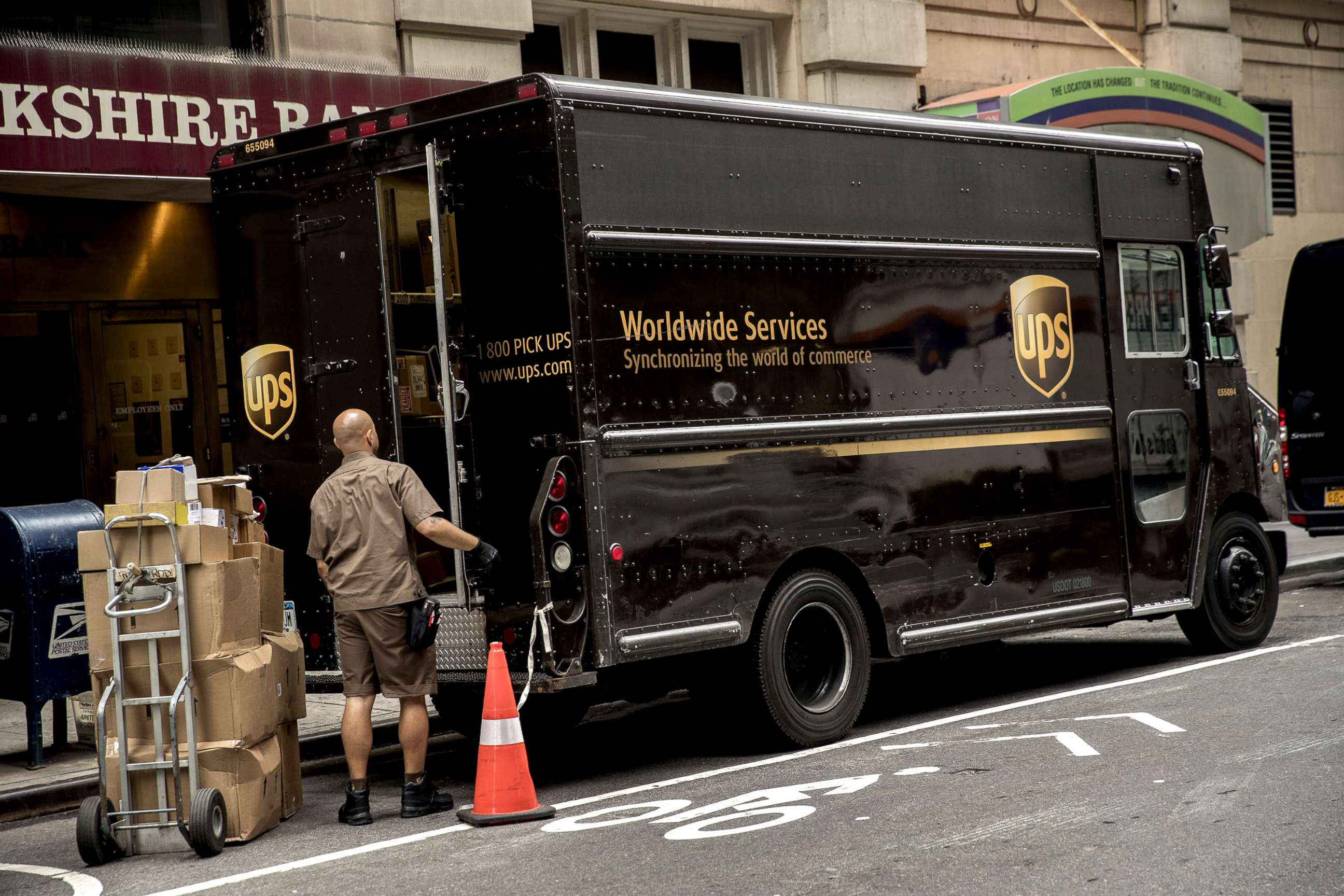 PHOTO: A driver for an independent contractor to United Parcel Service Inc. (UPS) prepares to load packages onto a delivery truck on a street in New York, July 24, 2017. 