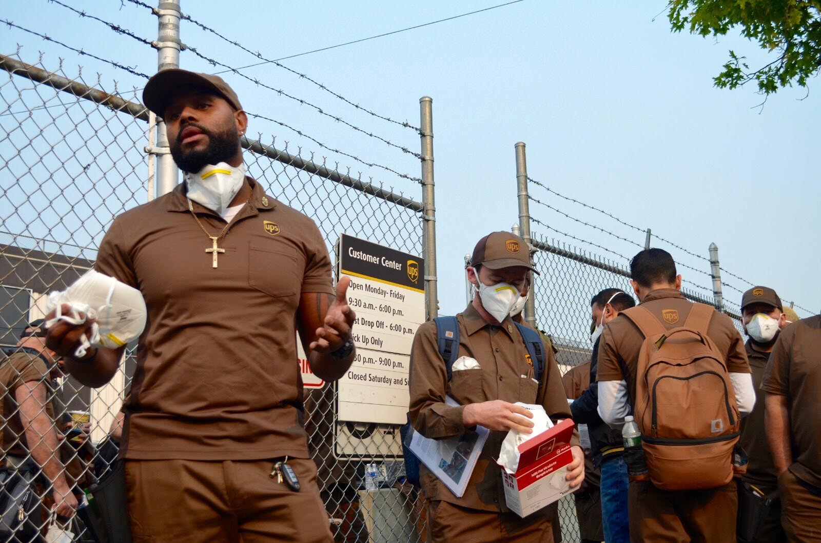 PHOTO: UPS drivers in Brooklyn, New York, put on masks before they head out for deliveries on June 8, 2023.
