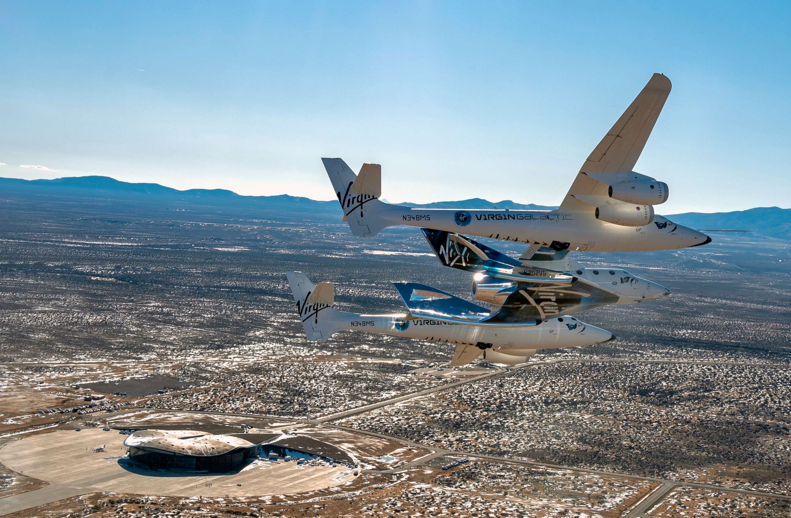 PHOTO: This Feb. 13, 2020, file photo shows the Virgin Galactic's VSS Unity flying over Spaceport America in Truth or Consequences, N.M.