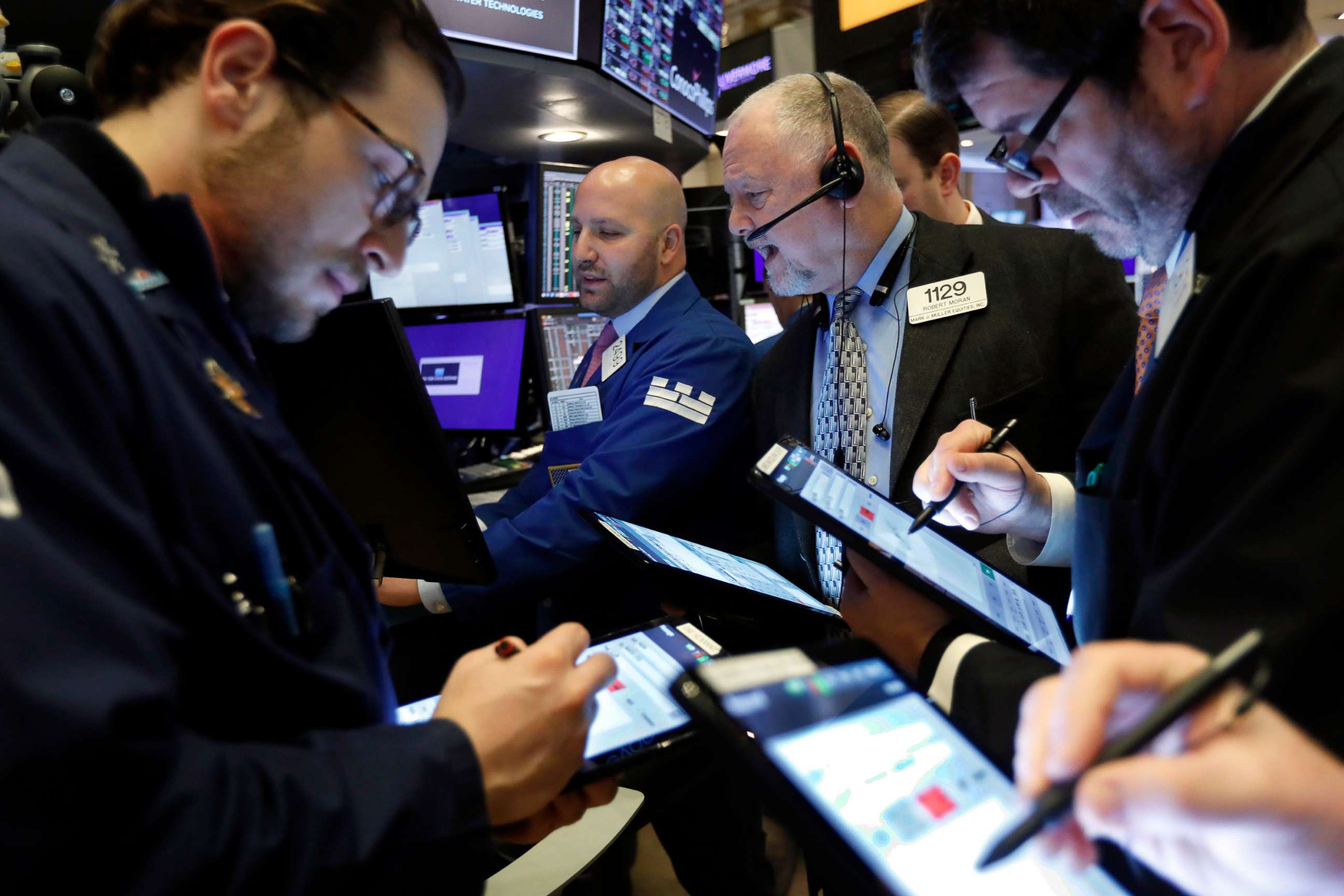 PHOTO: Specialist John Parisi, background center, works with traders at his post on the floor of the New York Stock Exchange, March 6, 2020.