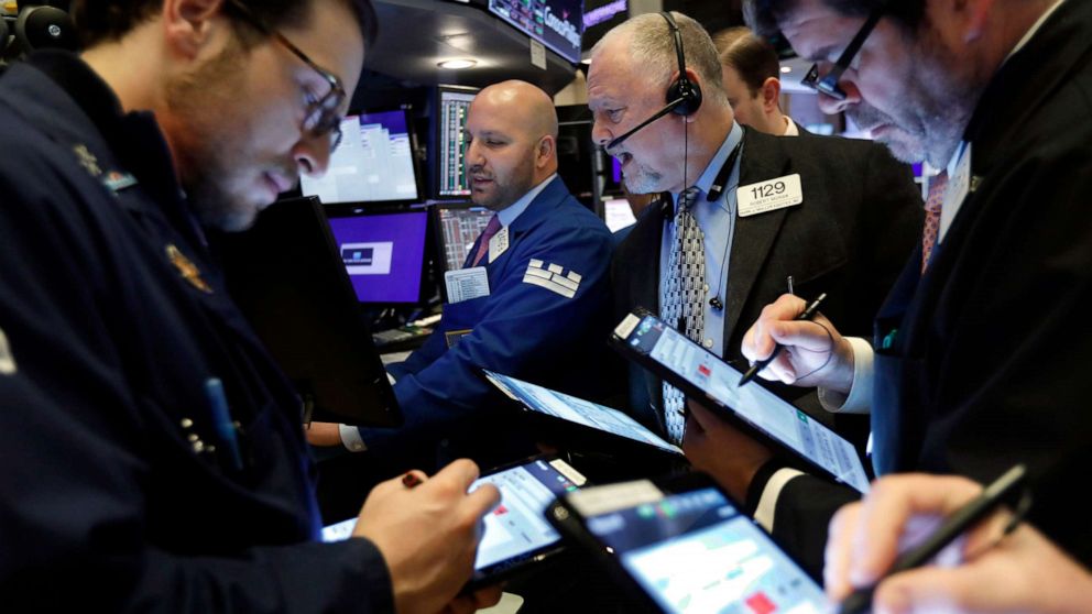 PHOTO: Specialist John Parisi, background center, works with traders at his post on the floor of the New York Stock Exchange, March 6, 2020.