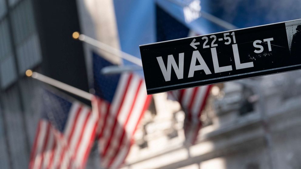 PHOTO: A sign for Wall Street hangs in front of the New York Stock Exchange, on July 8, 2021. Stocks are opening lower on Wall Street Thursday, June 9, 2022, putting major indexes into the red for the week.
