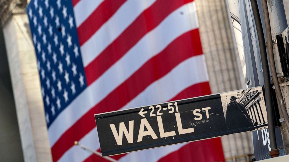 PHOTO: The Wall Street street sign is framed by a giant American flag hanging on the New York Stock Exchange, Sept. 21, 2020.