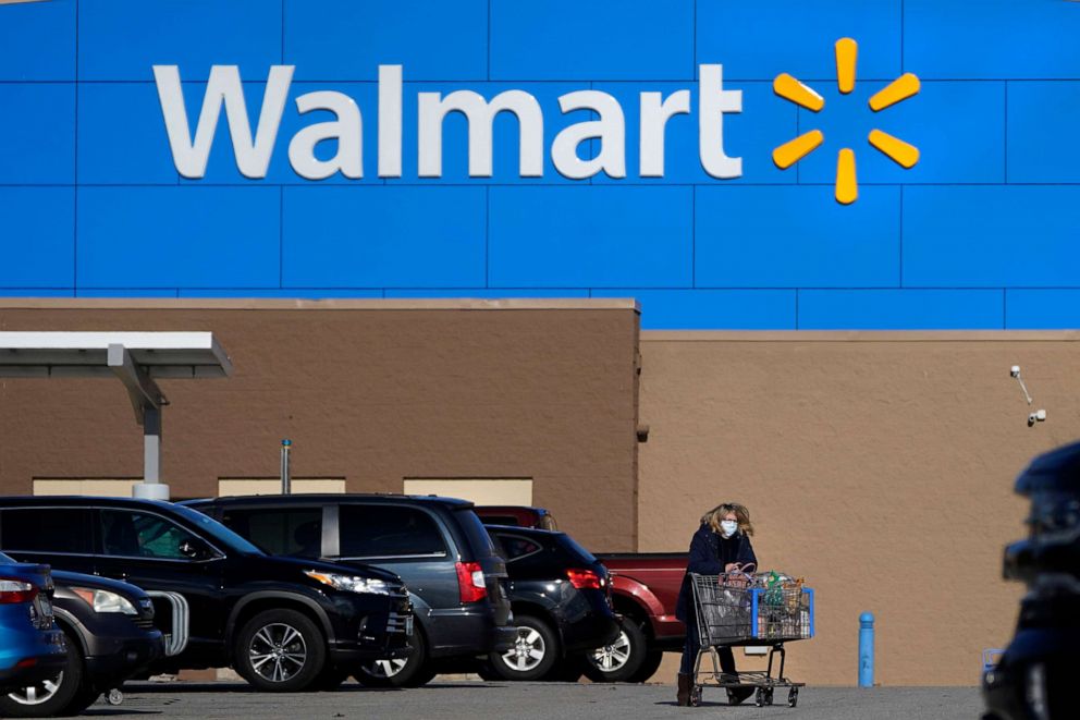 PHOTO: A woman wheels a cart with her purchases out of a Walmart, Nov. 18, 2020, in Derry, N.H.