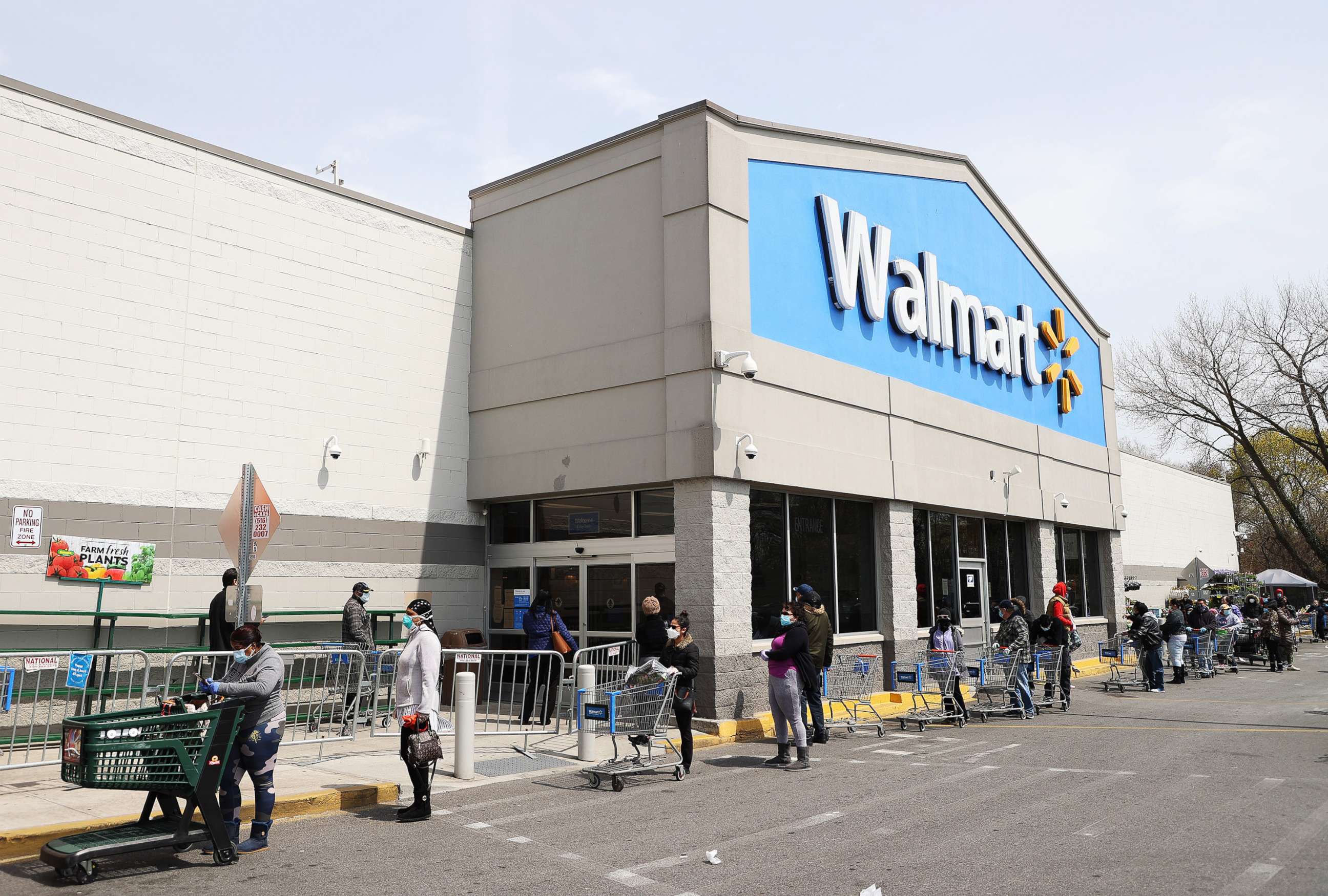 PHOTO: People wearing masks and gloves wait to enter a Walmart on April 17, 2020 in Uniondale, N.Y.