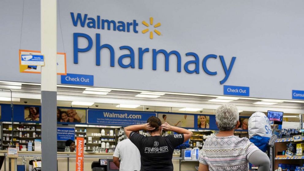 PHOTO: Shoppers wait in line to be served at the pharmacy at Walmart in Charlotte, N.C., Sept. 13, 2018. 