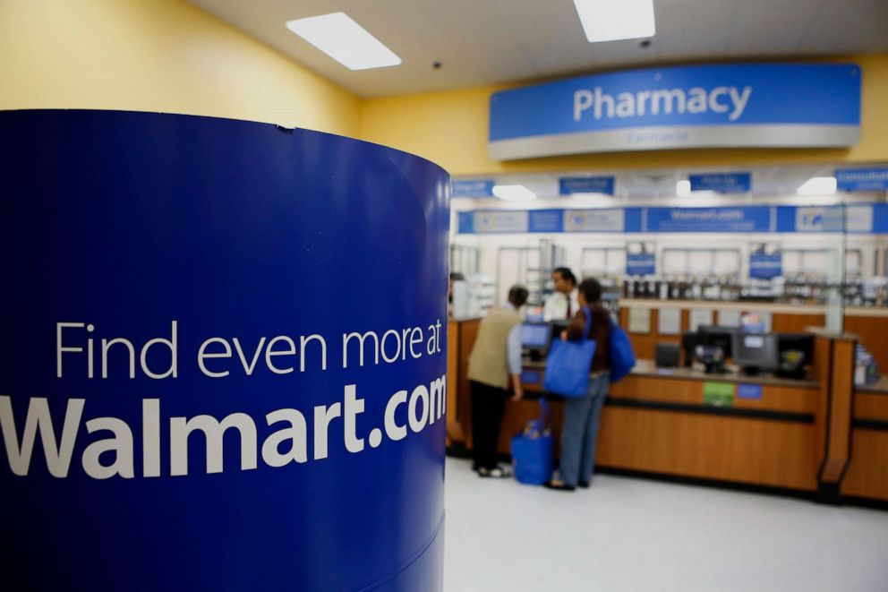 PHOTO: Signage points customers to Walmart.com at the pharmacy exit Wal-Mart in the Chinatown neighborhood of Los Angeles, Sept. 19, 2013.