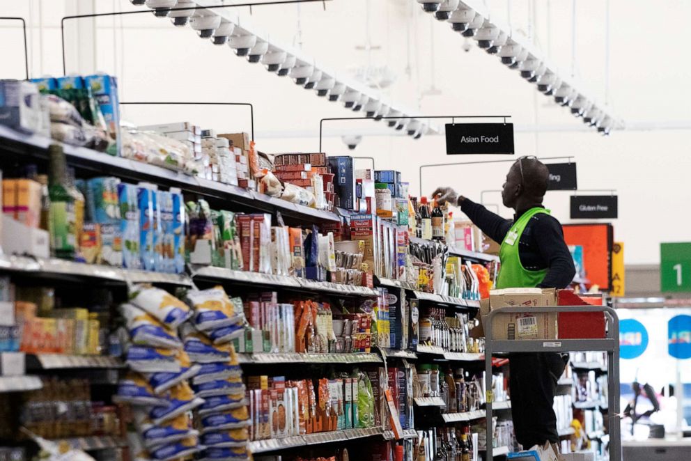 PHOTO: A Walmart associate arranges items on a shelf at a Walmart Neighborhood Market, Wednesday, April 24, 2019, in Levittown, N.Y.