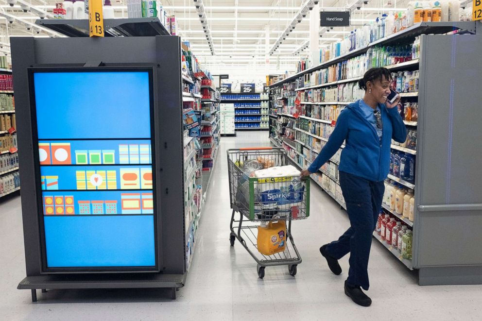 PHOTO: A customer pulls her shopping cart past an information kiosk at a Walmart Neighborhood Market, April 24, 2019, in Levittown, N.Y.