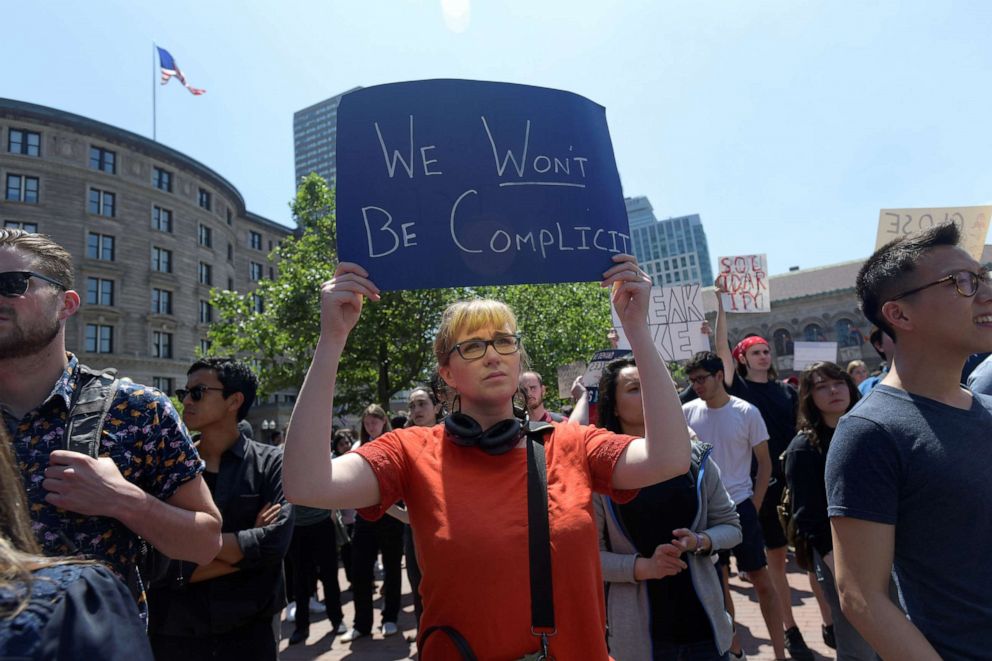 PHOTO: A woman holds up a sign during a demonstration by Wayfair employees protesting the company's sales of beds and furniture to U.S. border detention facilities, on Copley Plaza in Boston, June 26, 2019.