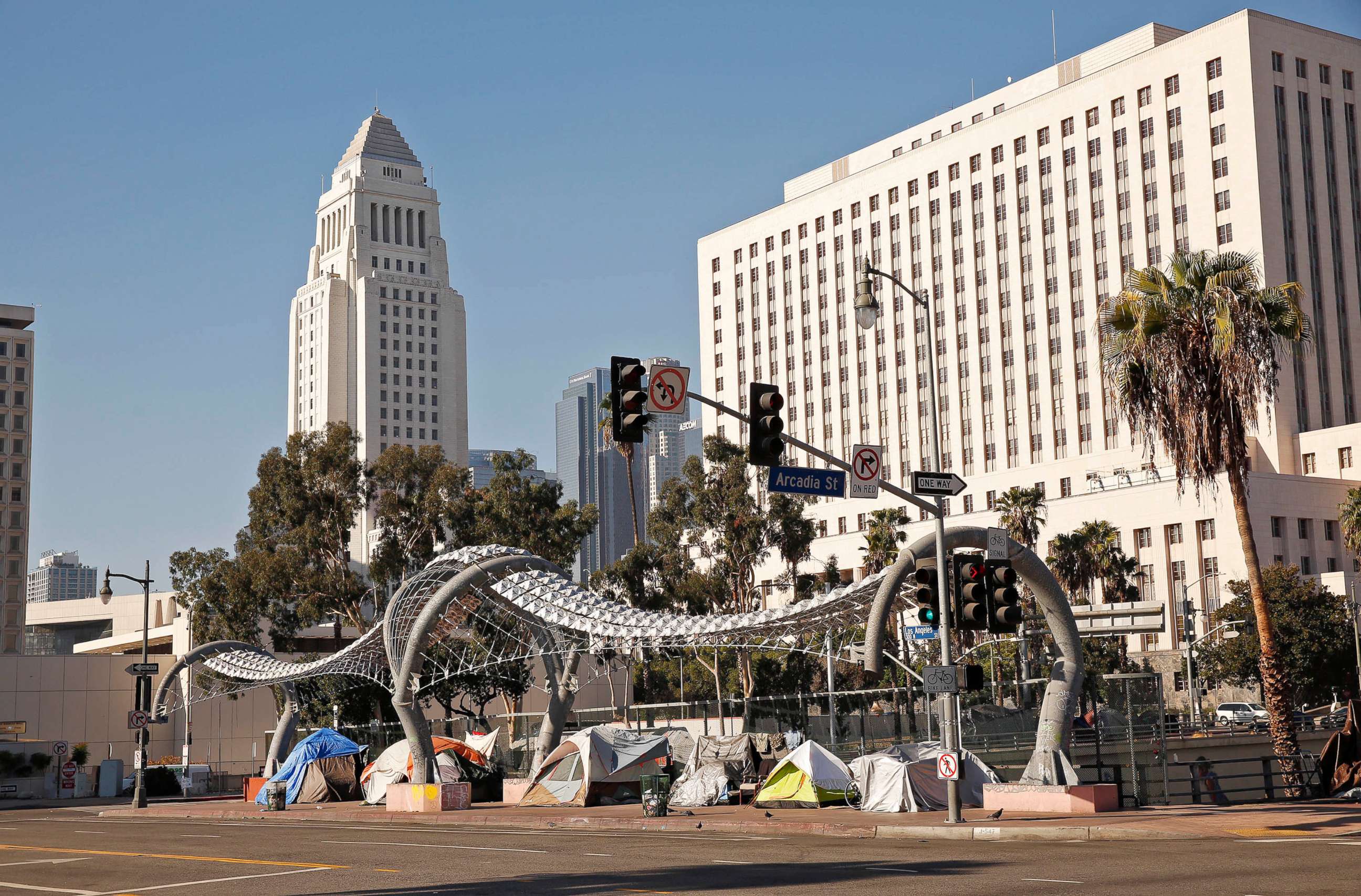 PHOTO: Unhoused people live in tents along Los Angeles Street over the 101 Freeway in Downtown Los Angeles, Nov. 13, 2020.