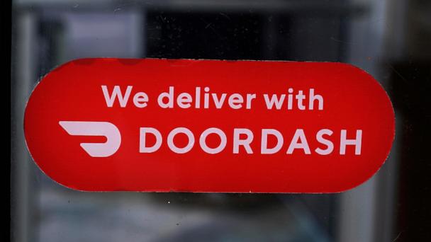 FILE - A DoorDash sign is posted on the door of a Dunkin' Donuts franchise, Feb. 27, 2023, in Methuen, Mass. (AP Photo/Charles Krupa, File)