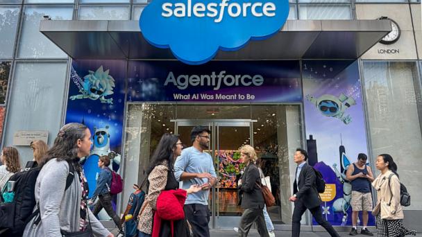 FILE - People walk past the Salesforce Tower in New York on Thursday, May 8, 2025. (AP Photo/Ted Shaffrey, File)