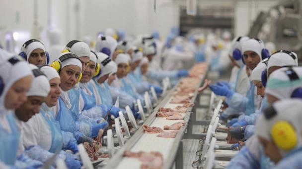 FILE - Workers prep poultry at the meatpacking company JBS, in Lapa, in the Brazilian state of Parana, March 21, 2017. (AP Photo/Eraldo Peres, File)