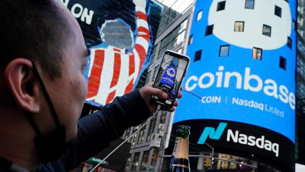 FILE - The Coinbase logo covers the Nasdaq MarketSite in New York's Times Square, April 14, 2021. (AP Photo/Richard Drew, File)