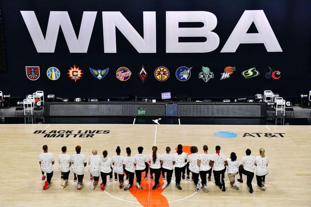 PHOTO: After the WNBA announcement of the postponed games for the evening, the Washington Mystics each wear white T-shirts with seven bullets on the back, protesting the shooting of Jacob Blake police in Kenosha, Wisc. on Aug. 26, 2020, in Palmetto, Fla.