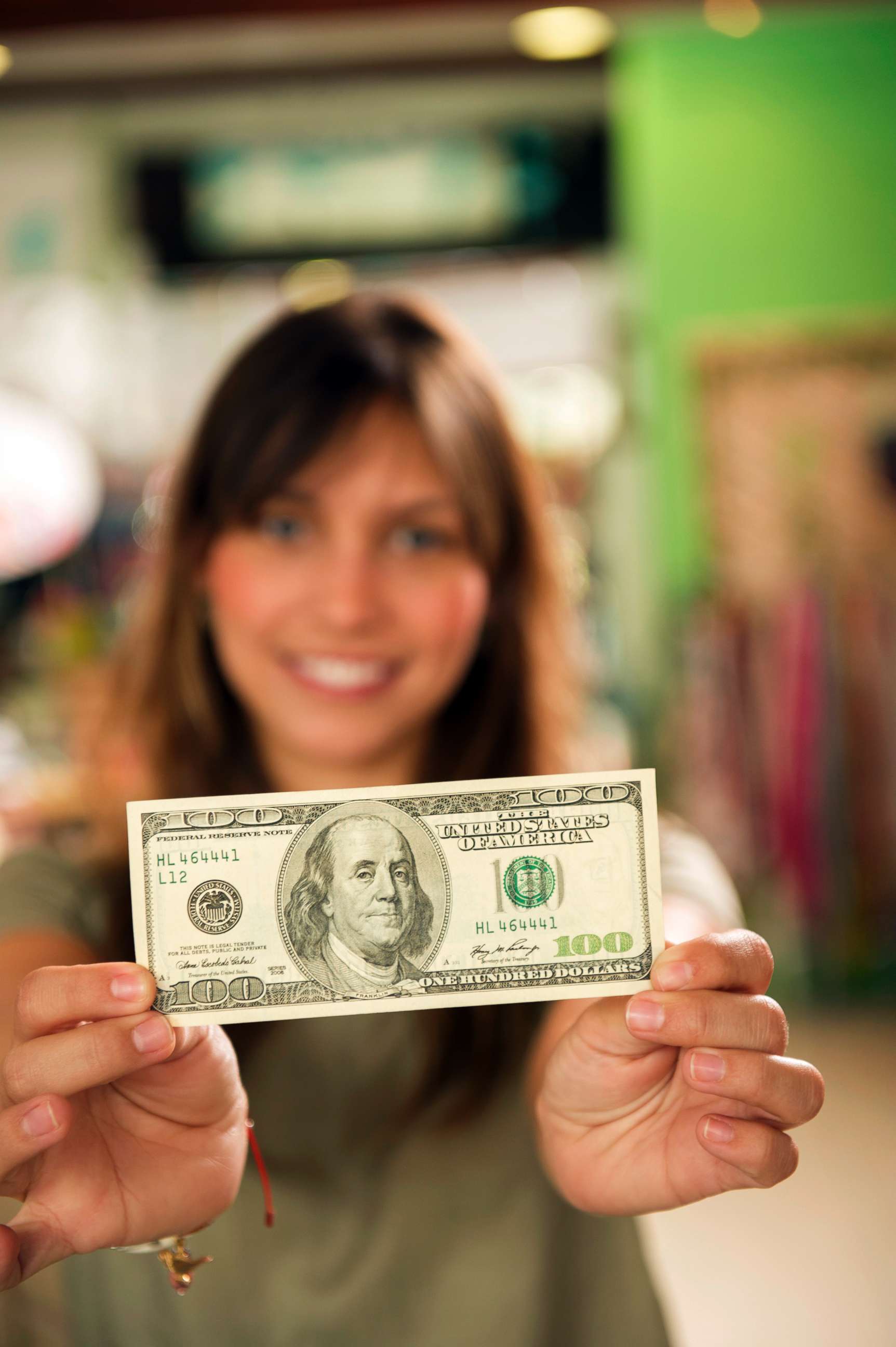 PHOTO: A woman holds a $100 bill in an undated stock photo.