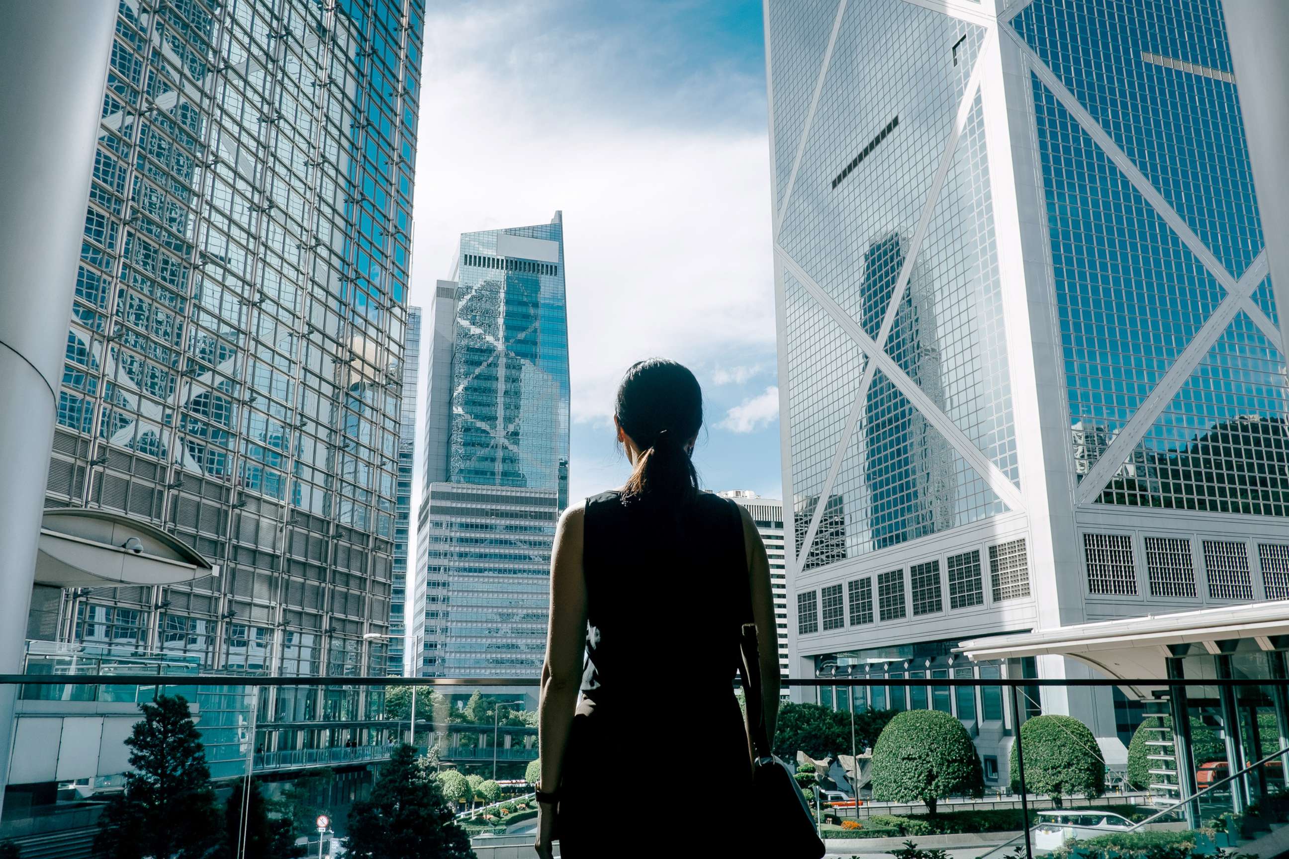 PHOTO: A woman poses holding a laptop computer in a corporate business settting in an undated stock image.