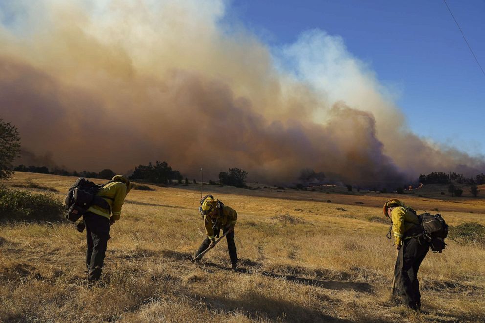 PHOTO: Firefighters work to remove flammable materials to prevent fire from spreading during the Zogg fire near the town of Igo in Shasta County, Calif., Sept. 27, 2020.