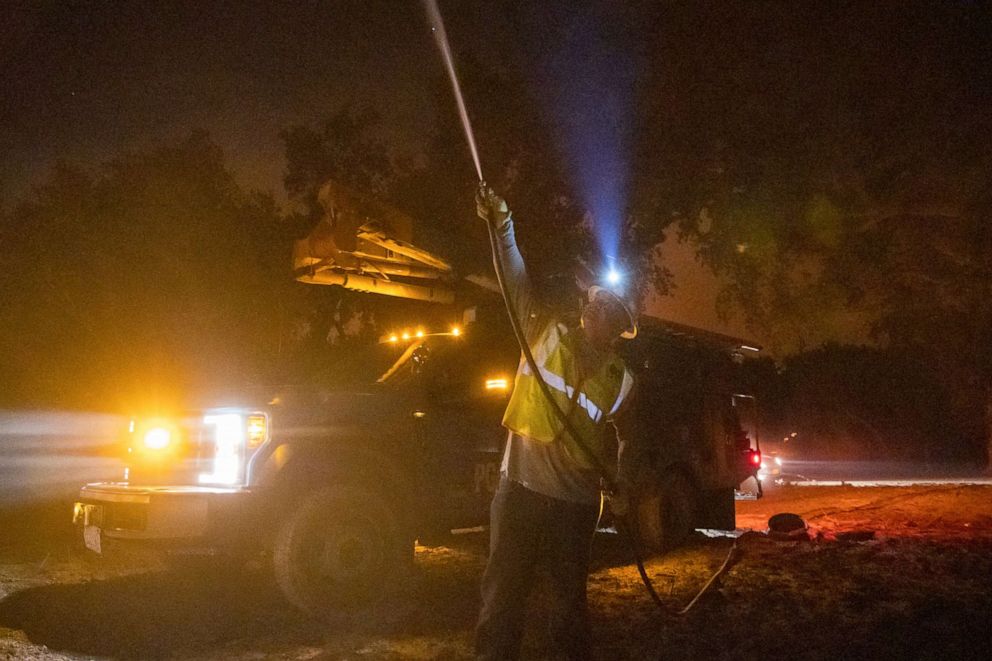 PHOTO: A Pacific Gas & Electric employee sprays water on a burning telephone pole at the Zogg Fire near Ono, Calif., Sept. 28, 2020.