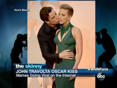 VIDEO: John Travolta gave Scarlett Johansson a kiss on the cheek while on the red carpet. 