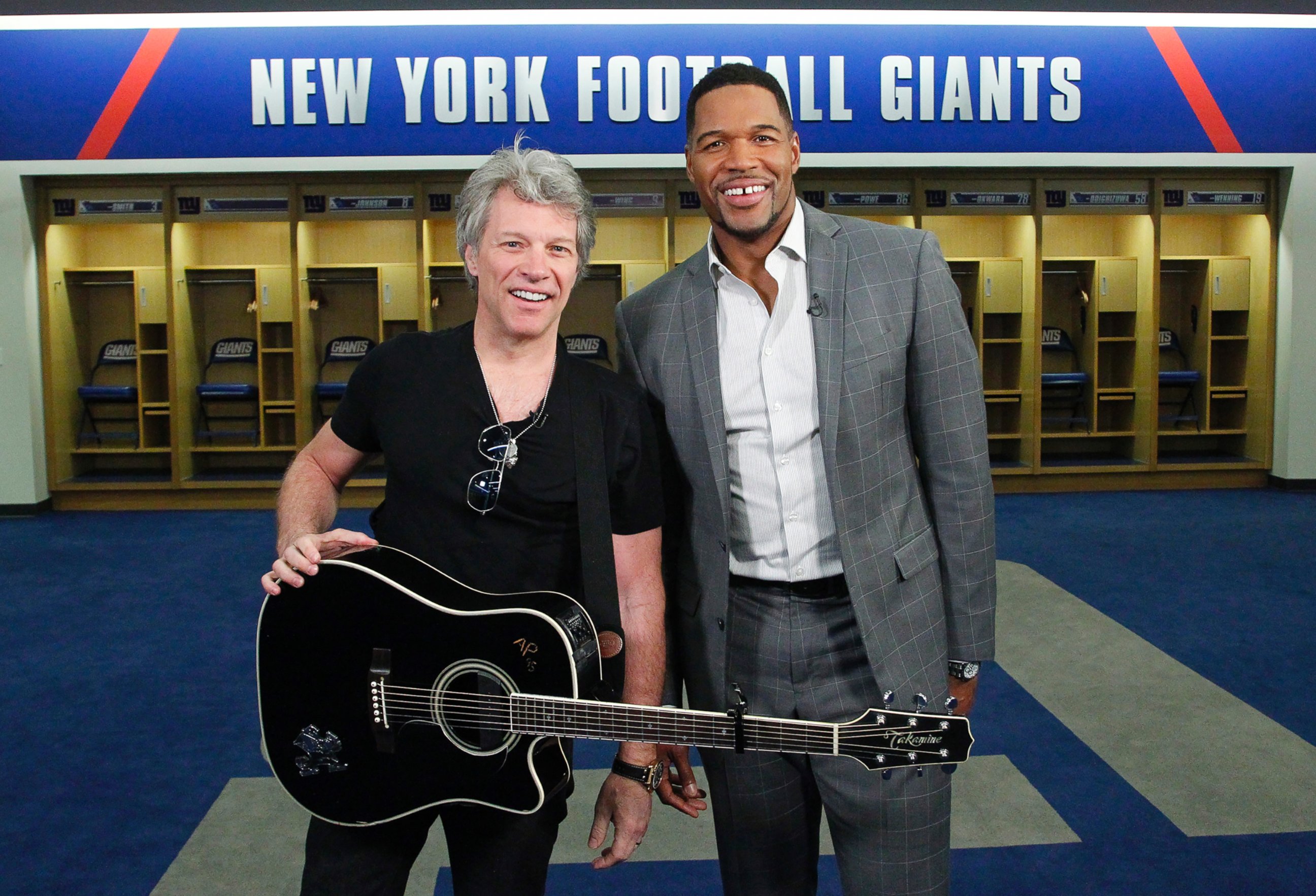 PHOTO: ABC News' Michael Strahan, right, joined Jon Bon Jovi at MetLife Stadium in New Jersey as the rock singer surprised the graduating class at Fairleigh Dickinson University commencement with a performance.